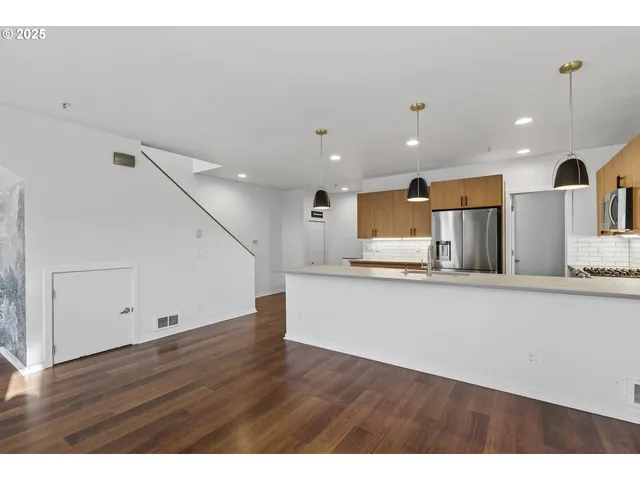 a view of kitchen with cabinets and wooden floor
