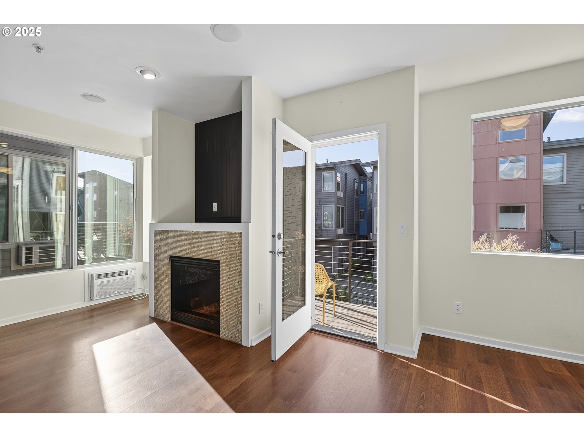 8083 North Leavitt Avenue Portland, OR 97203 - Photo 18 of 34 a view of an empty room with wooden floor and a fireplace