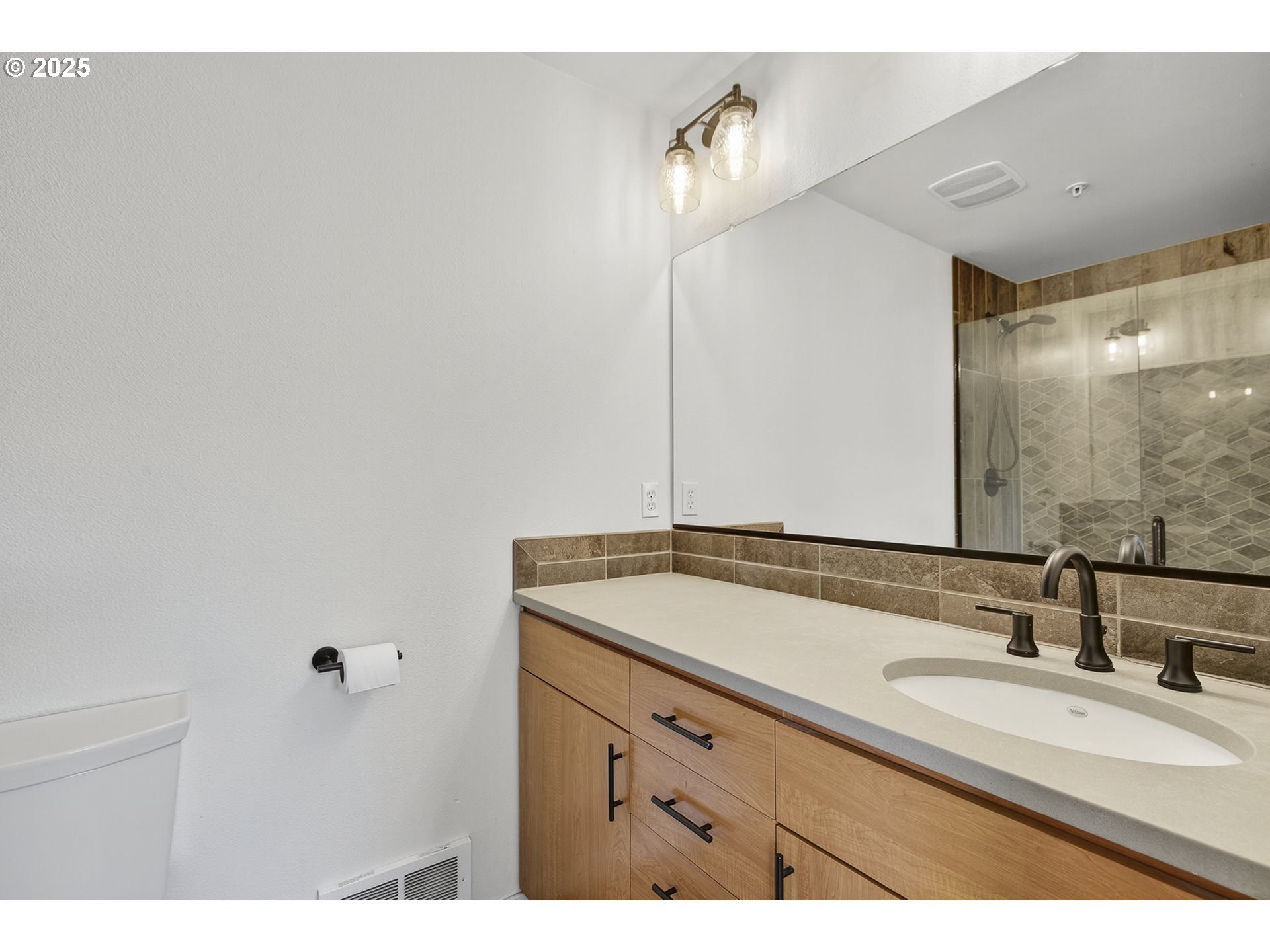 8083 North Leavitt Avenue Portland, OR 97203 - Photo 29 of 34 a bathroom with a sink and a mirror