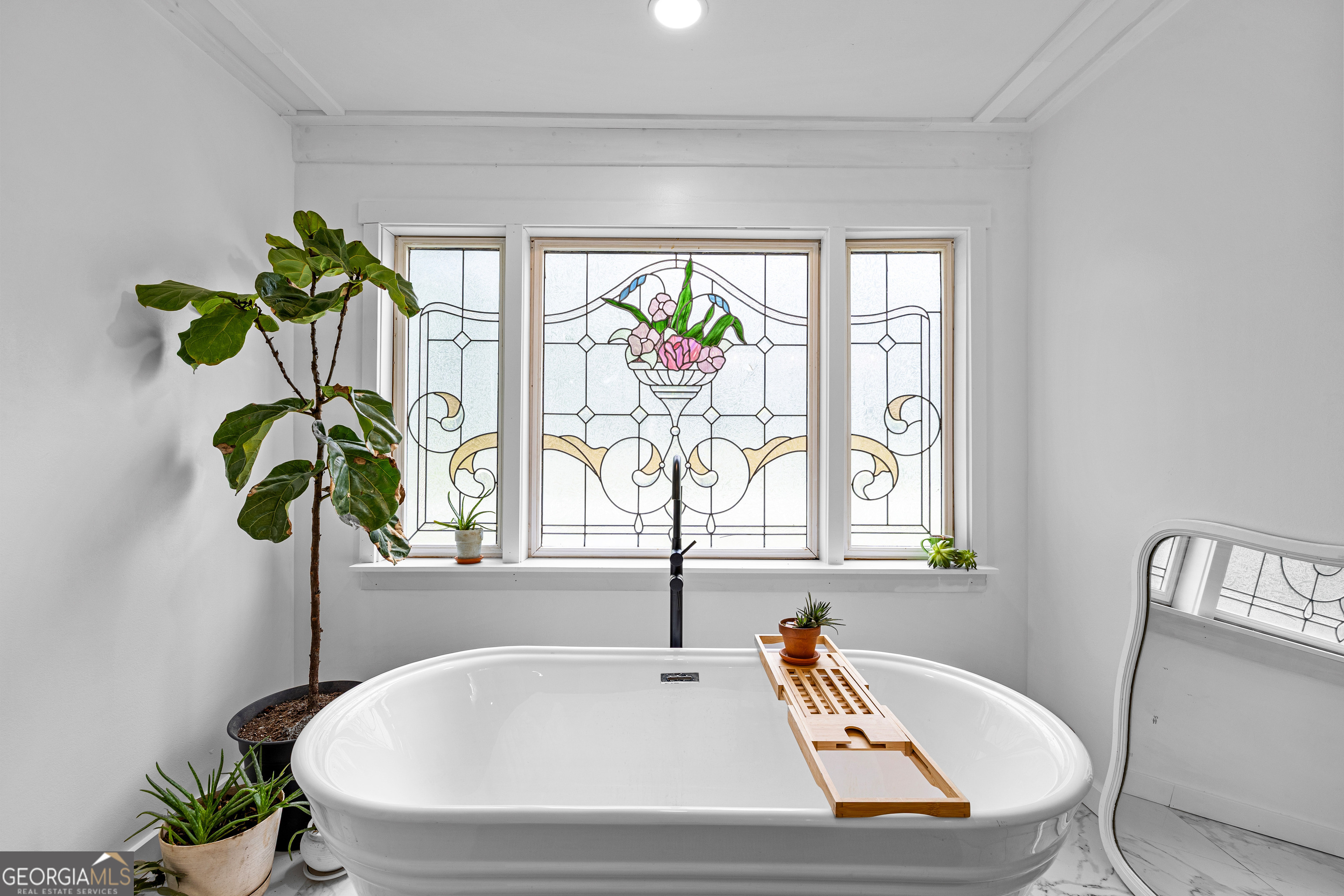 1329 Standing Rock Road Senoia, GA 30276 - Photo 38 of 77 a bathroom with a tub a sink and a window