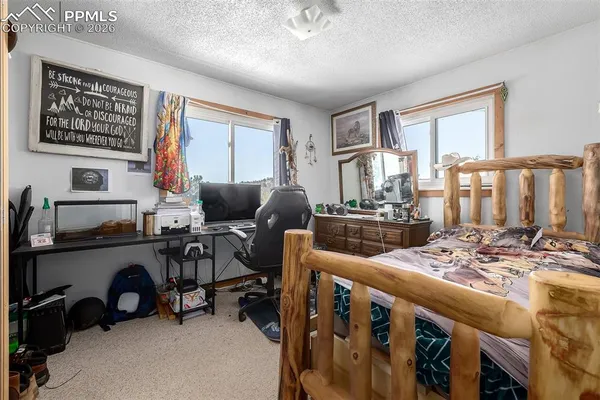 a view of a livingroom with workspace and a window