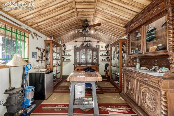 a room with lots of wooden furniture and a chandelier