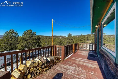 a view of a balcony with wooden floor and fence