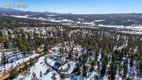 an aerial view of residential houses with city view
