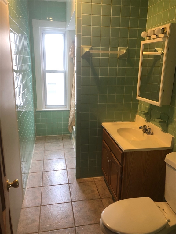 21 Whipple Street, Unit 3 Worcester, MA 01607 - Photo 2 of 8 a bathroom with a sink a toilet and mirror