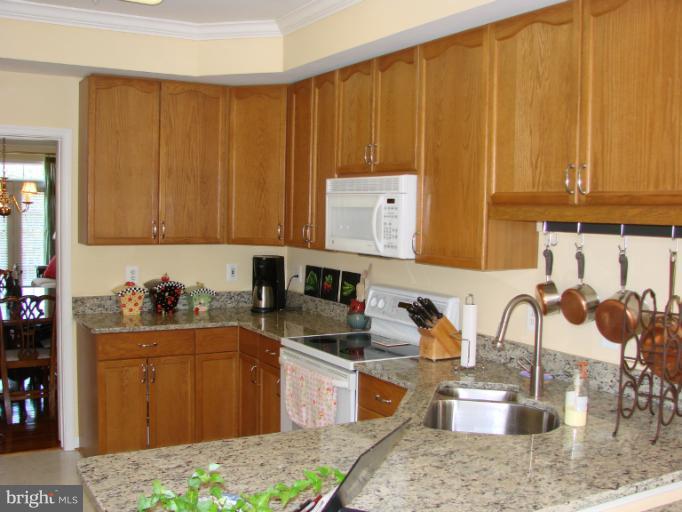 2205 Bear Den Road Frederick, MD 21701 - Photo 4 of 19 a kitchen with stainless steel appliances granite countertop a sink dishwasher stove and cabinets