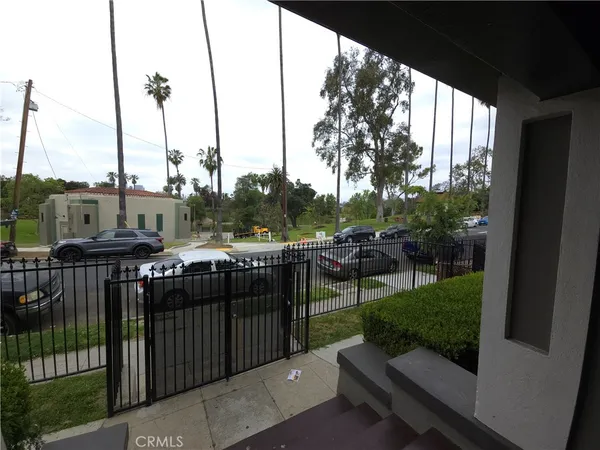 a view of a deck with wooden floor barbeque oven and yard