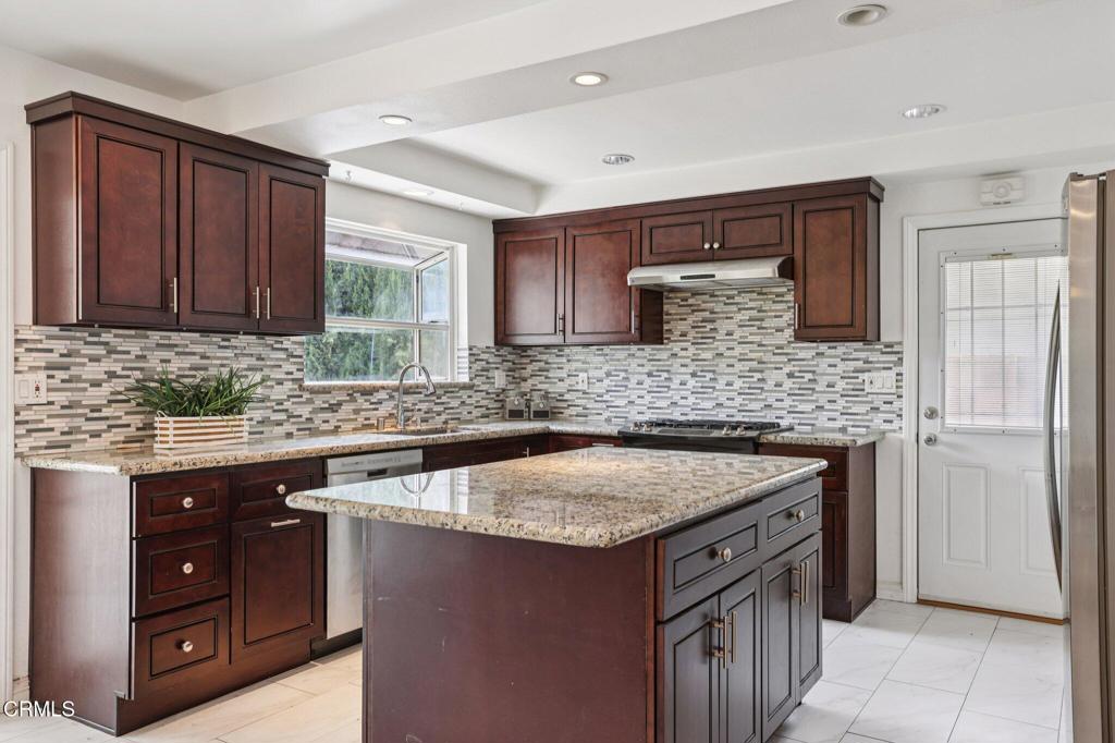 10856 Topeka Drive Porter Ranch, CA 91326 - Photo 12 of 39 a kitchen with a sink stove and cabinets