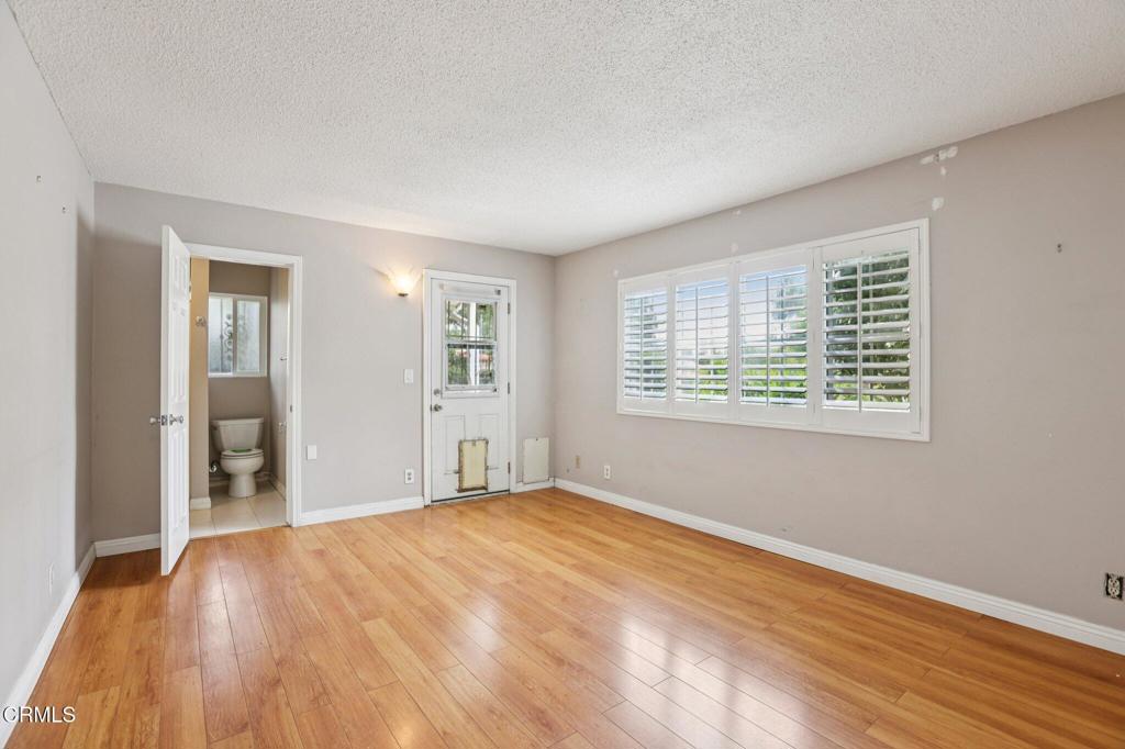 10856 Topeka Drive Porter Ranch, CA 91326 - Photo 15 of 39 a view of an empty room with wooden floor and a window