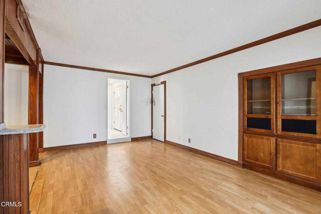 10856 Topeka Drive Porter Ranch, CA 91326 - Photo 19 of 39 an empty room with wooden floor and windows