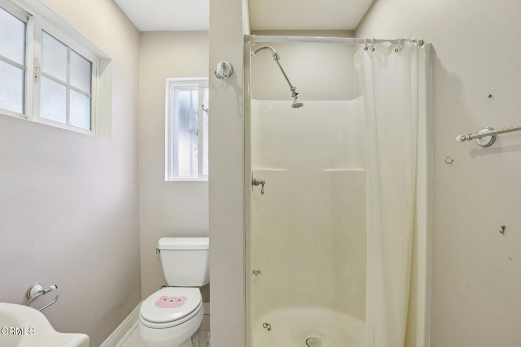 10856 Topeka Drive Porter Ranch, CA 91326 - Photo 20 of 39 a white toilet sitting next to a bathroom sink