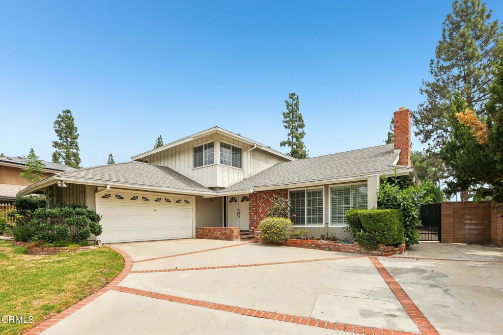 10856 Topeka Drive Porter Ranch, CA 91326 - Photo 3 of 39 a front view of a house with a yard and potted plants