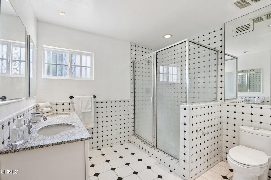 10856 Topeka Drive Porter Ranch, CA 91326 - Photo 32 of 39 a bathroom with a sink toilet and shower