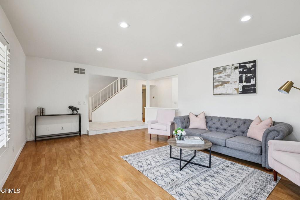 10856 Topeka Drive Porter Ranch, CA 91326 - Photo 8 of 39 a living room with furniture and a wooden floor