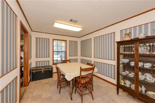 a view of a dining room with furniture and a window