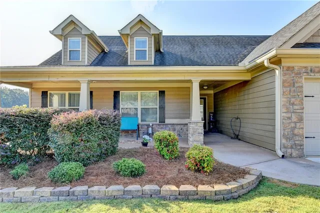 a front view of a house with garden