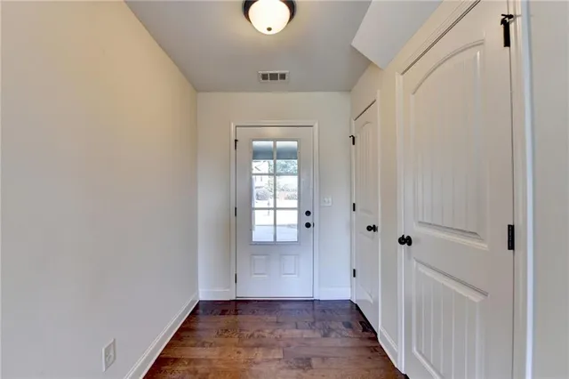 a view of a hallway with wooden floor
