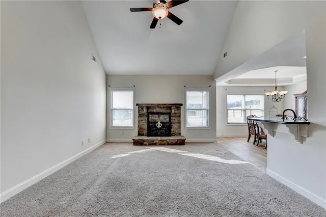 a view of a livingroom with a fireplace and window