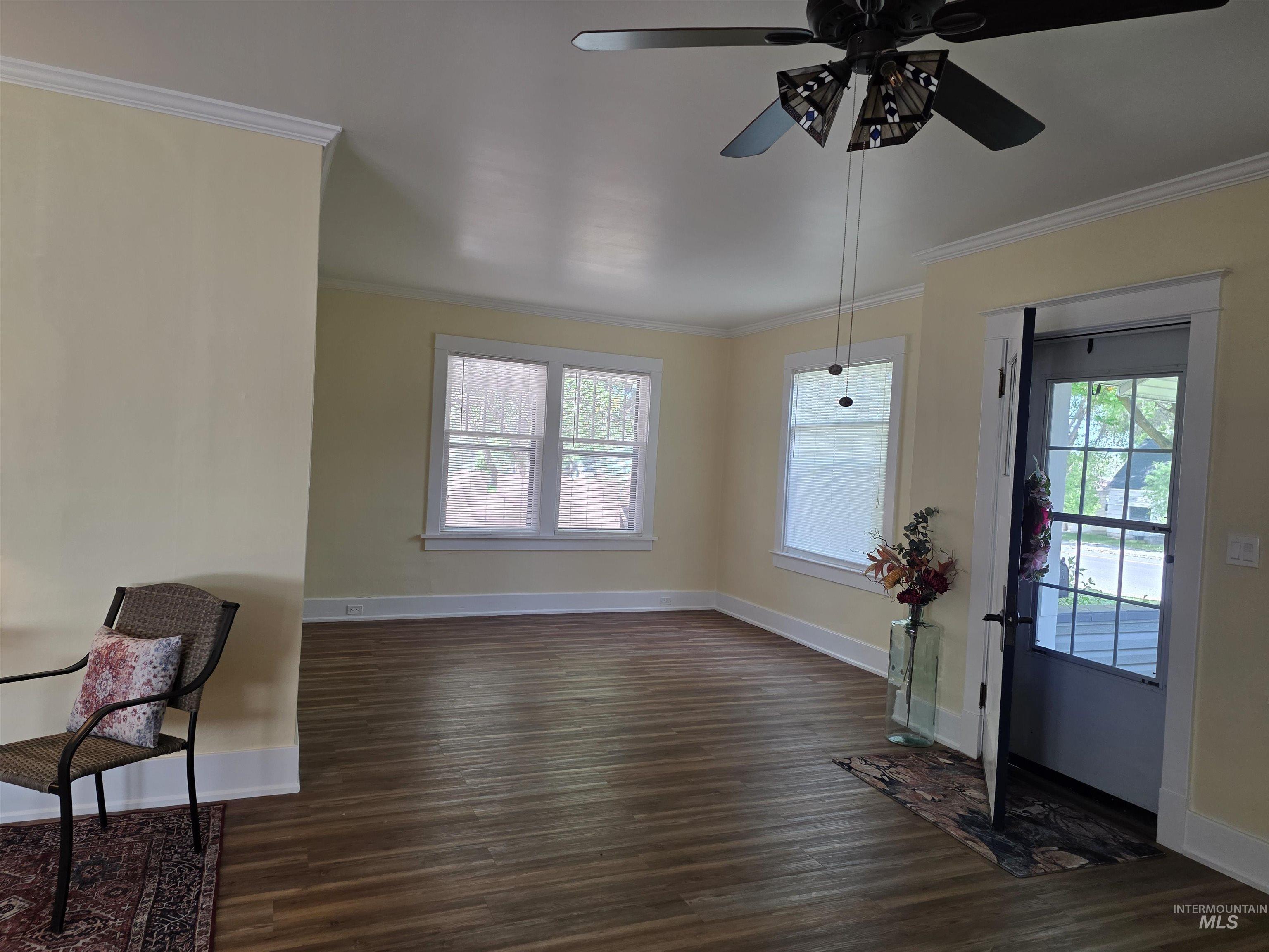 421 East Main Street Jerome, ID 83338 - Photo 6 of 13 Spacious interior featuring wood-finish flooring, light-colored walls, and classic crown molding