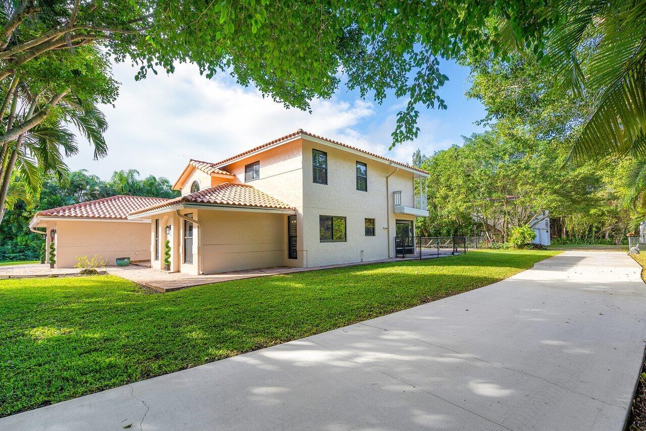 5515 Colbright Road Lake Worth, FL 33467 - Photo 52 of 58 side of the home from concrete driveway