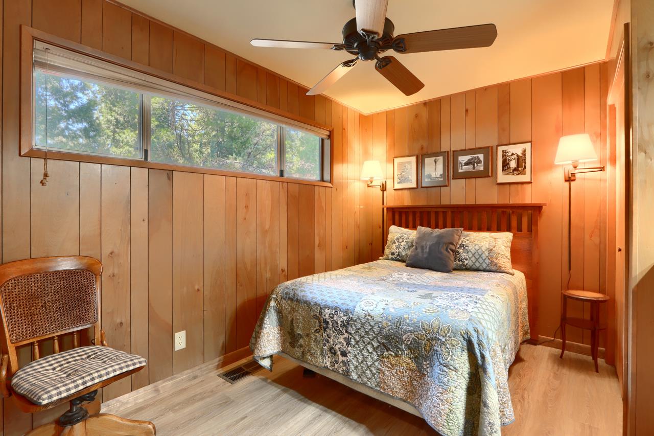 8067 Chilnualna Falls Road Wawona, CA 95389 - Photo 16 of 42 a bedroom with a bed and a window