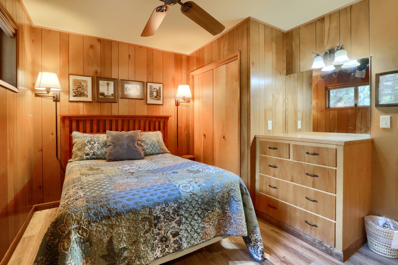 8067 Chilnualna Falls Road Wawona, CA 95389 - Photo 17 of 42 a bedroom with a bed and a cabinets