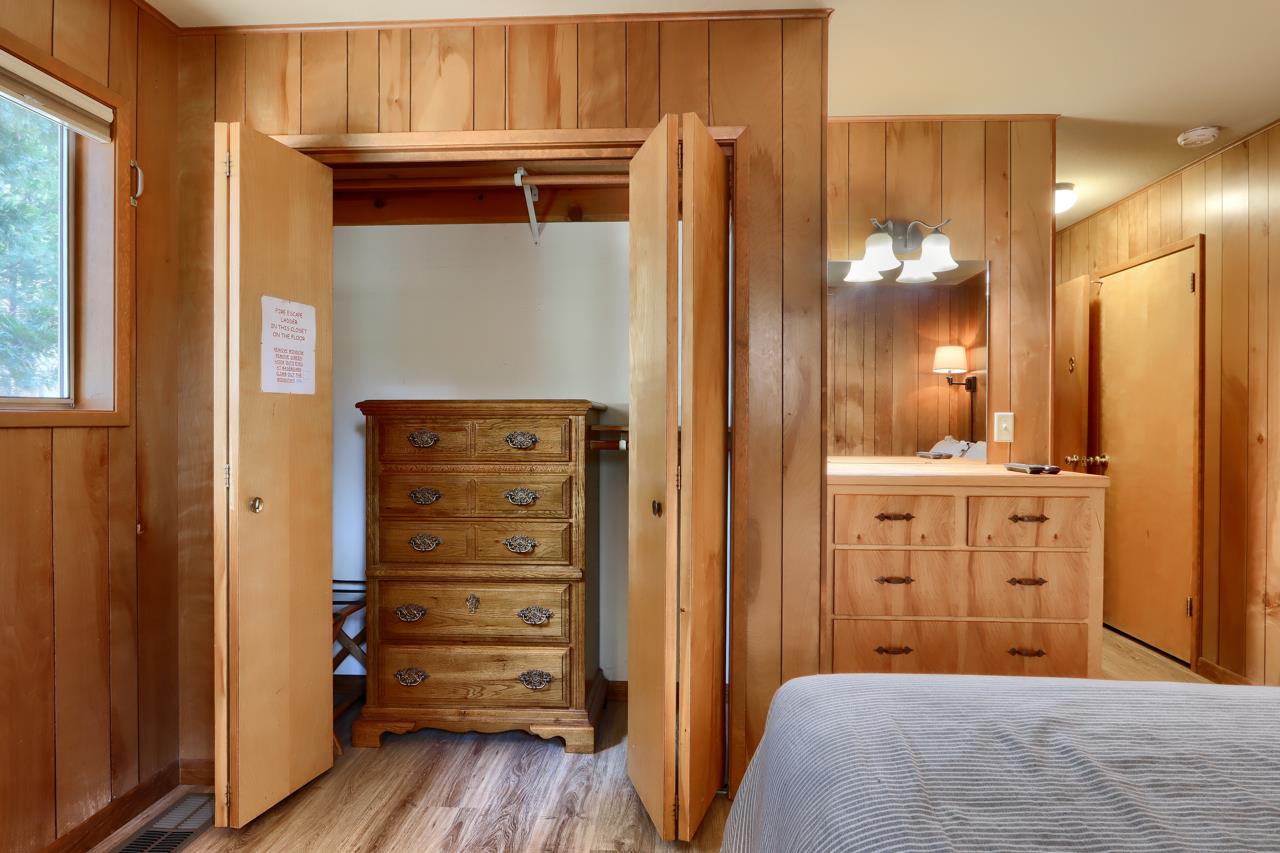 8067 Chilnualna Falls Road Wawona, CA 95389 - Photo 21 of 42 a view of a hallway with closet and wooden floor