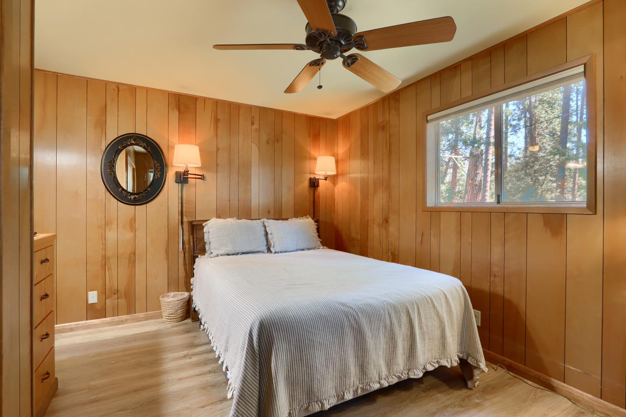 8067 Chilnualna Falls Road Wawona, CA 95389 - Photo 22 of 42 a bedroom with a bed and a window