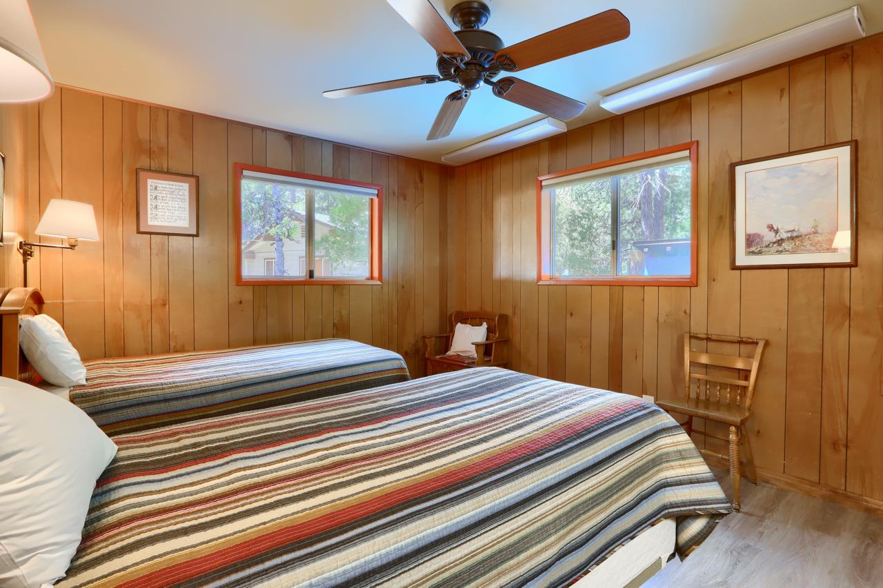 8067 Chilnualna Falls Road Wawona, CA 95389 - Photo 24 of 42 a bedroom with a bed and wooden floor