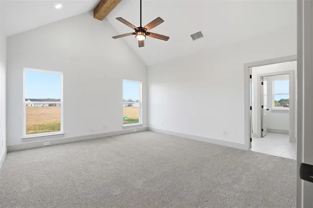 an empty room with fan and windows