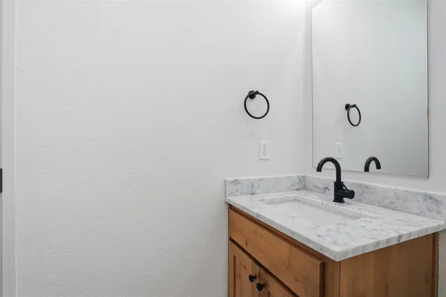 a bathroom with a sink and vanity