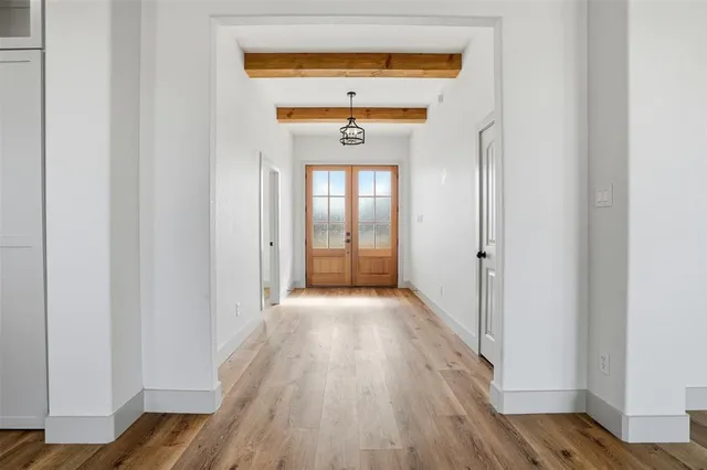 a view of a hallway view with wooden floor and staircase