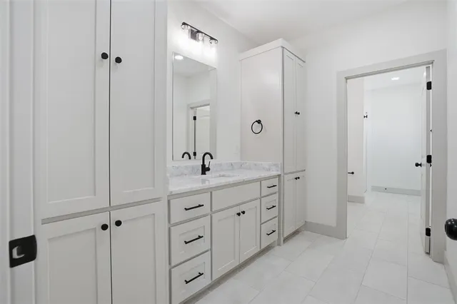 a bathroom with a double vanity sink shower and mirror