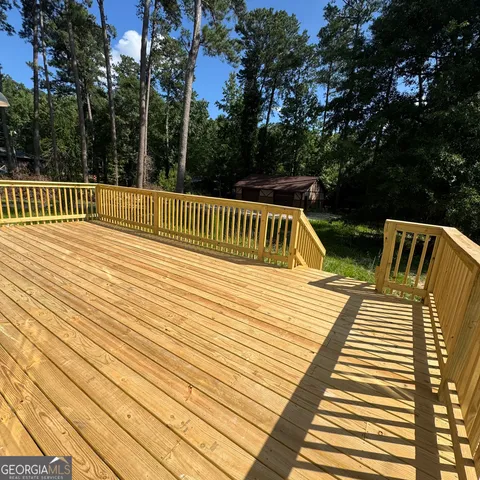 a view of a roof deck with couches and wooden floor