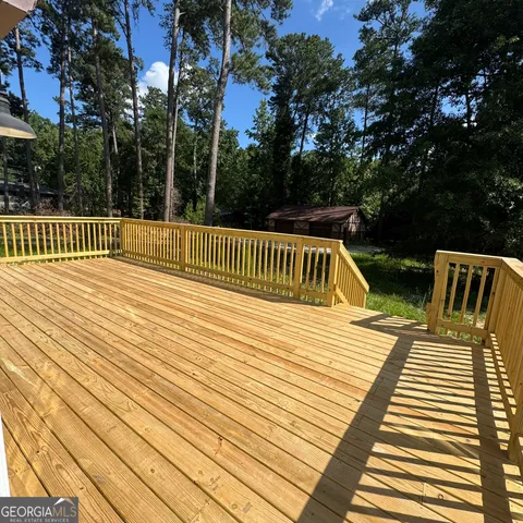 a view of deck with wooden floor and outdoor seating