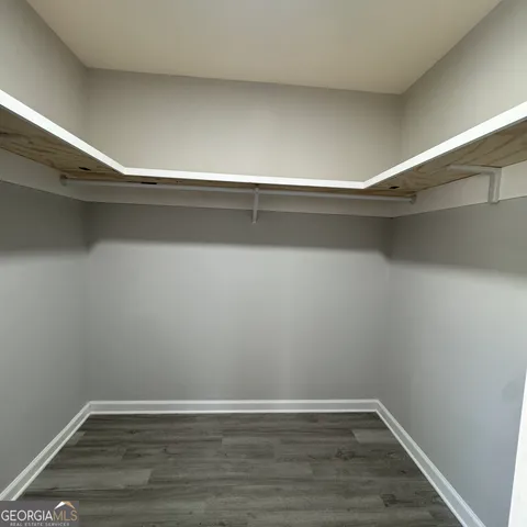 a view of a room with wooden floor