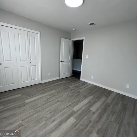 a view of an empty room and wooden floor