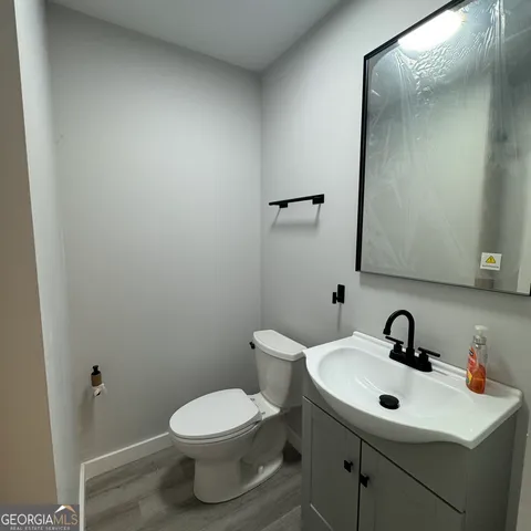 a bathroom with a sink mirror and toilet
