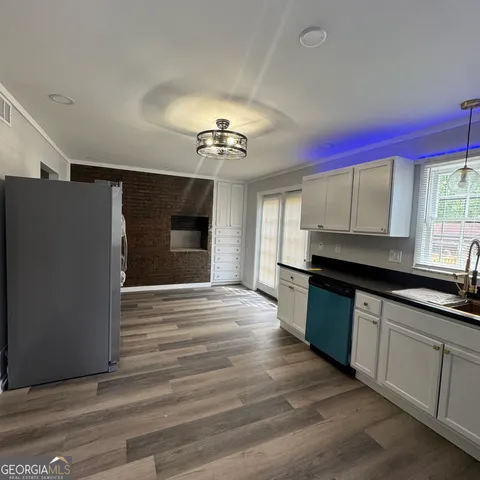 a kitchen with stainless steel appliances granite countertop a stove and a refrigerator