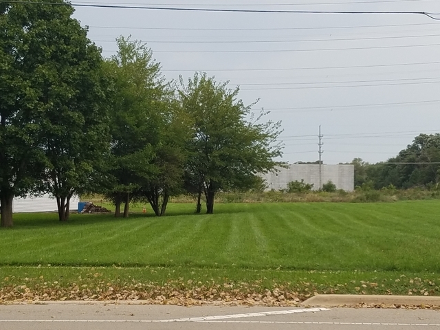 a view of grassy field with benches