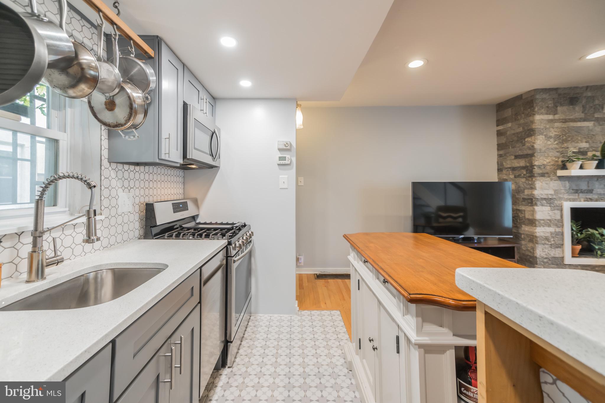 1032 Waverly Street Philadelphia, PA 19147 - Photo 11 of 30 a kitchen that has a sink and a stove