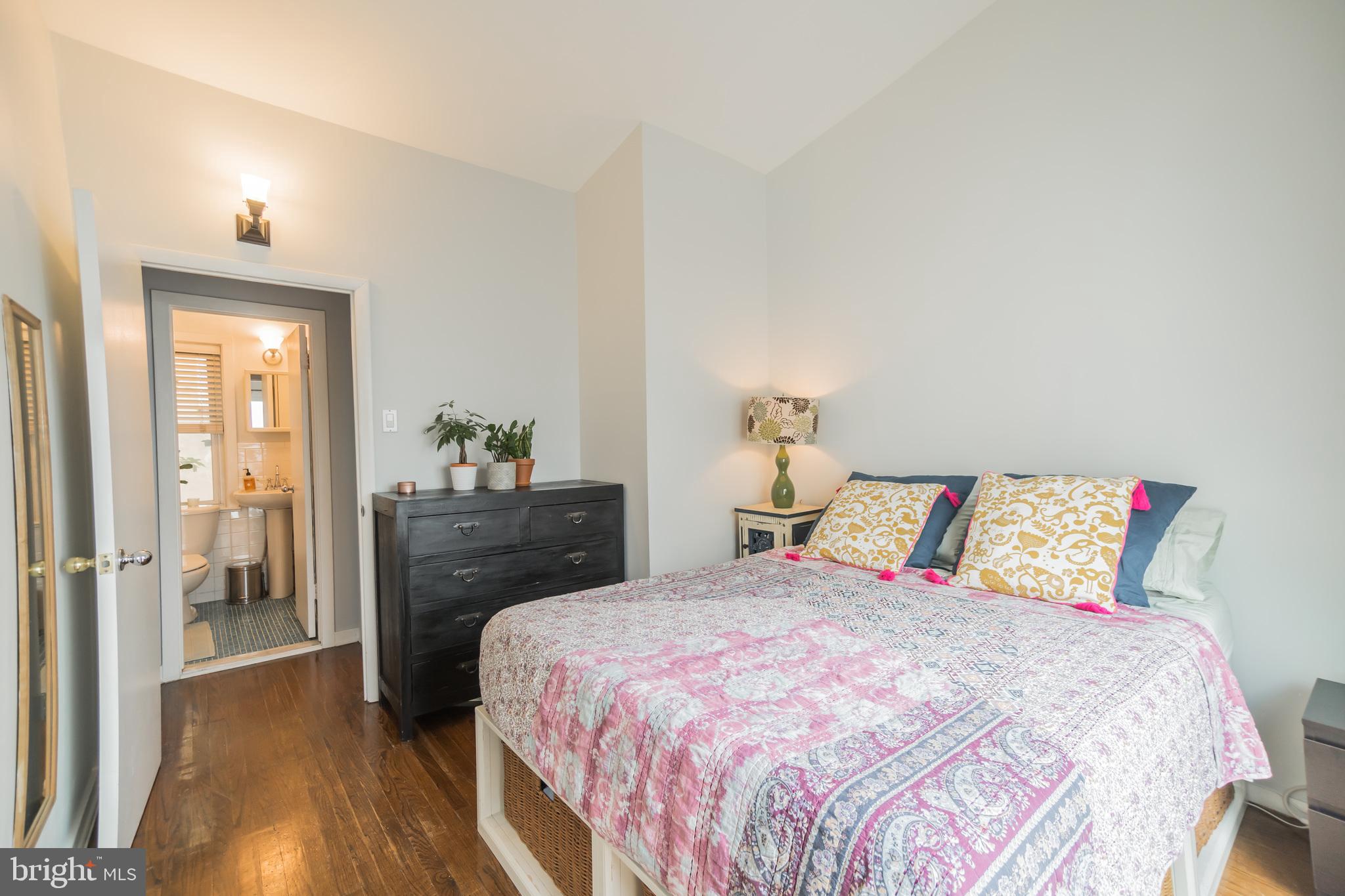 1032 Waverly Street Philadelphia, PA 19147 - Photo 17 of 30 a bedroom with a bed and wooden floor