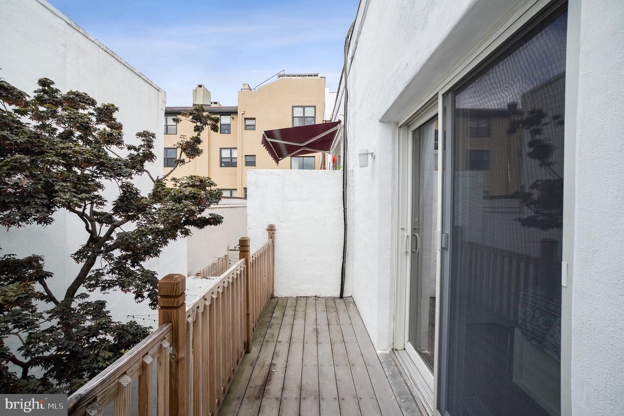 1032 Waverly Street Philadelphia, PA 19147 - Photo 20 of 30 a view of a balcony with wooden floor and fence