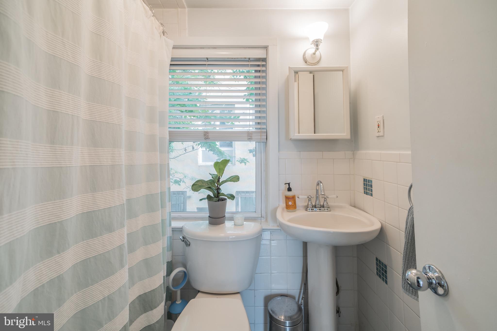 1032 Waverly Street Philadelphia, PA 19147 - Photo 25 of 30 a bathroom with a sink toilet and shower