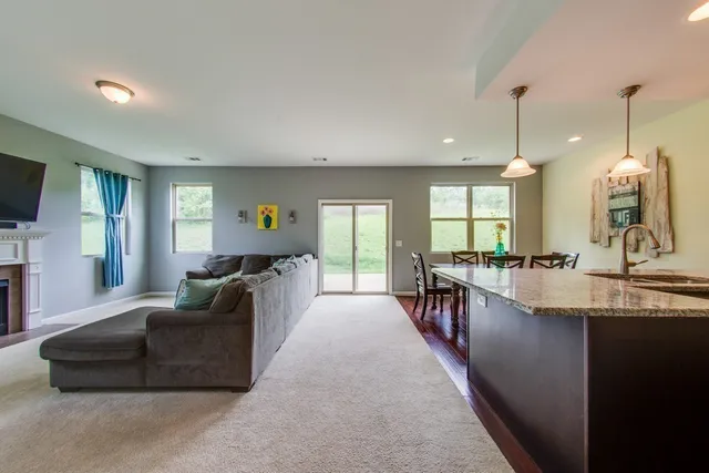 a large living room with a large window and a couch