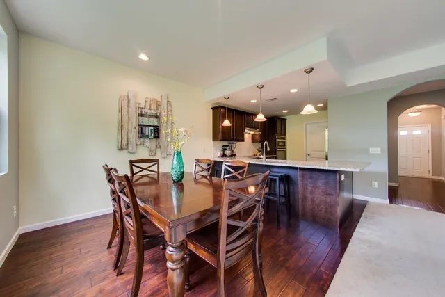 a view of a dining room with furniture and wooden floor