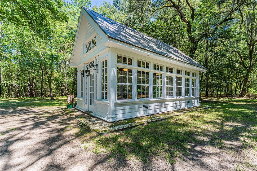 92 Dean Hall Road Seabrook, SC 29940 - Photo 1 of 99 South elevation of the glass house