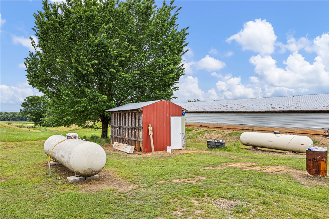 0 Wire Road Mulberry, AR 72947 - Photo 13 of 31 Red utility shed with a metal roof and white door