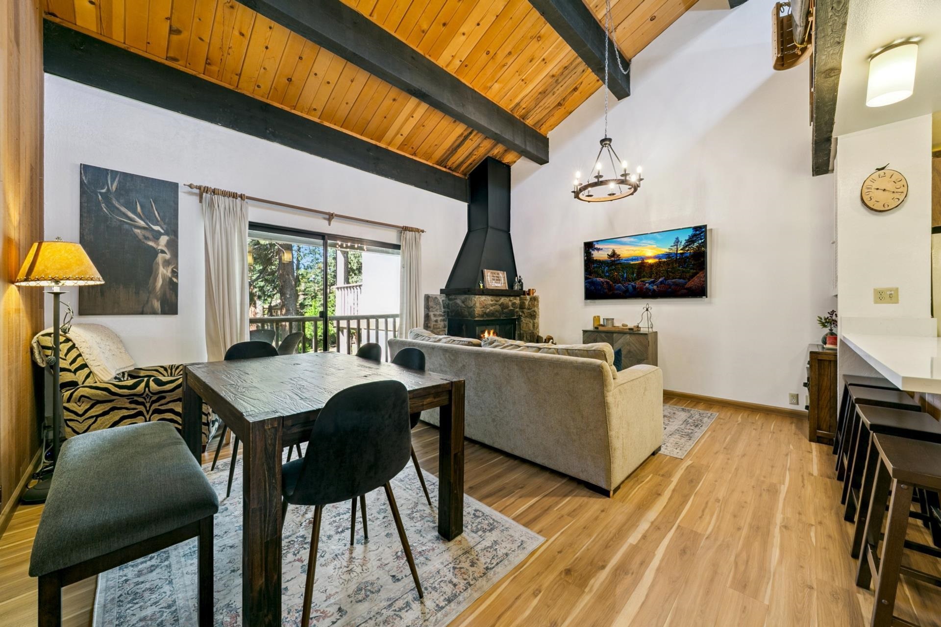 1001 Commonwealth Drive, Unit 114 Kings Beach, CA 96143 - Photo 1 of 23 a living room with furniture and a flat screen tv