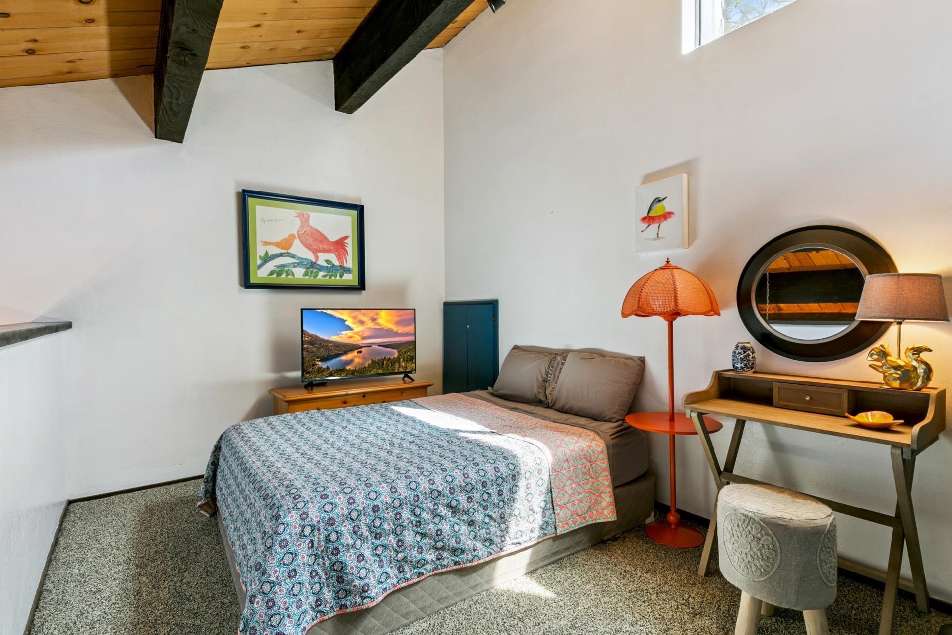 1001 Commonwealth Drive, Unit 114 Kings Beach, CA 96143 - Photo 13 of 23 a bedroom with a bed a standing fan and a baby crib